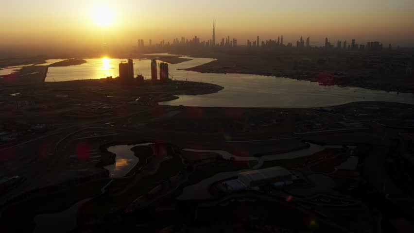 Aerial sunset view city skyscrapers Dubai Creek Commercial building Business area modern vehicle highway United Arab Emirates Persian Gulf Middle East Dubai RED WEAPON