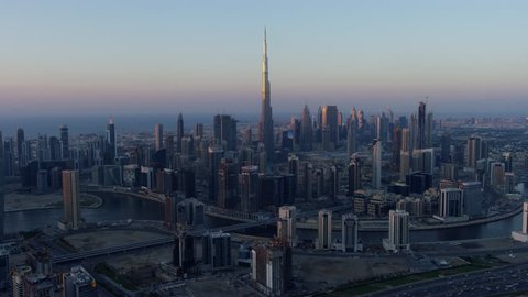 Aerial sunset city view Dubai Creek Downtown Business Bay commercial area modern vehicle transport highway United Arab Emirates Middle East Dubai RED WEAPON