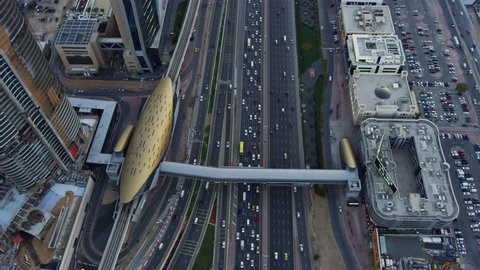 Aerial view overhead Dubai junction Intersection Sheikh Zayed Road Skyscrapers desert traffic elevated Roads Dubai Metro Rail transport UAE RED WEAPON