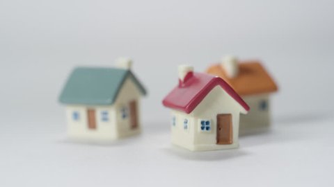 Investment Properties Money and Home Ownership Model toy house on white background