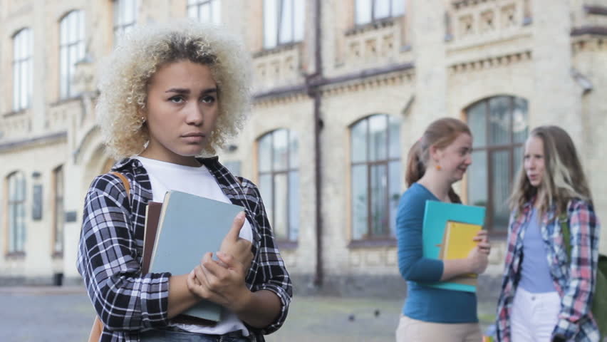 Envious adolescent girls classmates do not like beautiful afro-american newbie Royalty-Free Stock Footage #1015407487