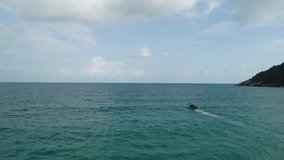 Drone footage. Thailand. Koh Phangan island. Top view aerial video. A motor boat sails in the sea. Beauty nature landscape on Thailand. Drone video. 4k.