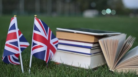 Education in England, English. Flag of Great Britain and books on the grass.