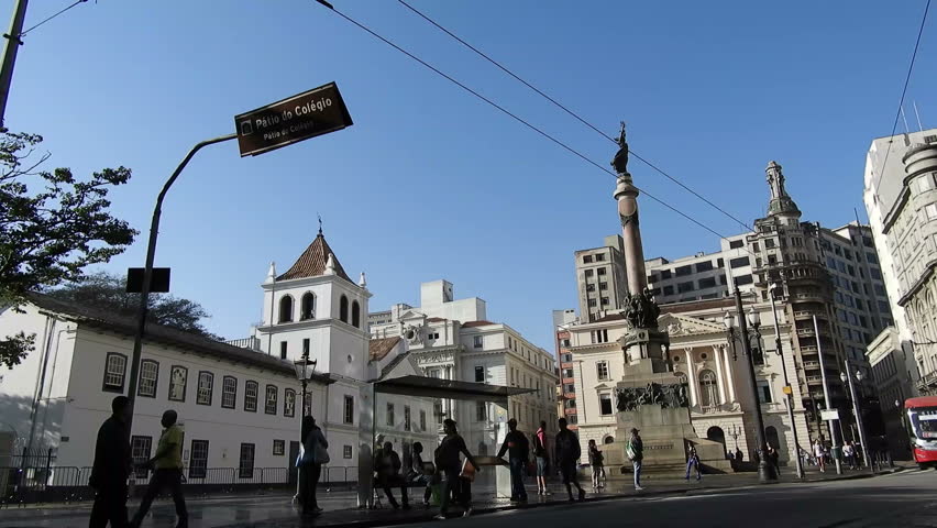 Sao Paulo, Brazil, June 29, 2018. Passengers board and wait for buses at a bus stop in front of Pateo do Collegio, the site of foundation of the city of Sao Paulo
