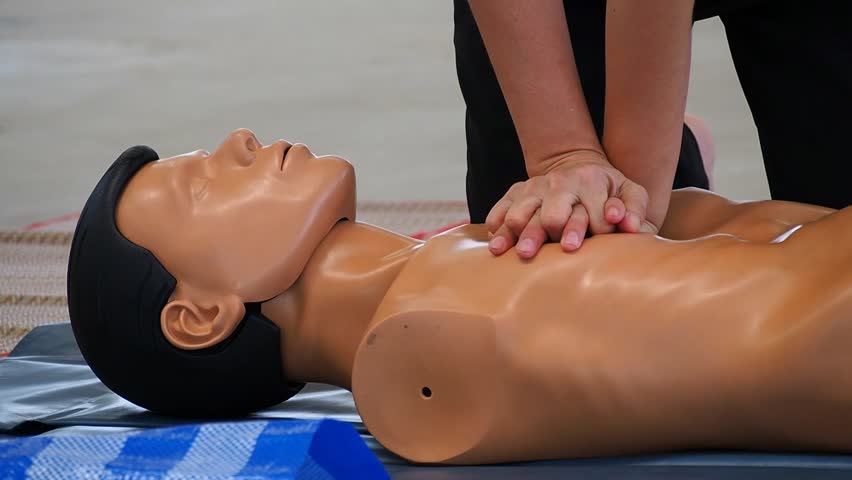 beside view demonstrating chest compression on CPR doll in the class. first Aid tranning Royalty-Free Stock Footage #1015422631