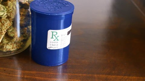 SLIDER SHOT Marijuana in glass jar and Rx for recreational or prescription medicinal weed smoking.