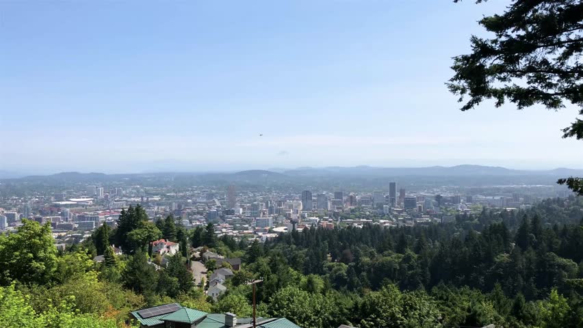 Helicopter flying directly over downtown Portland, Oregon, USA. View from Pittock Mansion and Mt. Hood in the distance. Royalty-Free Stock Footage #1015423261