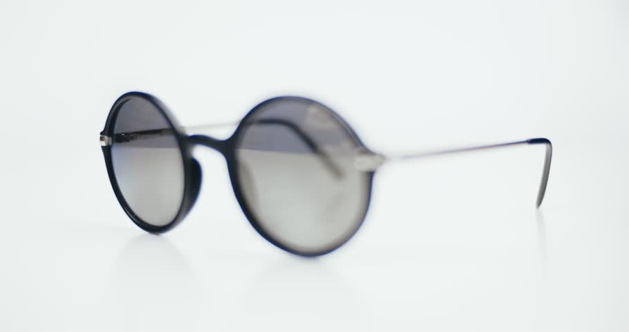 Retro sun proof glasses isolated on white background. Sunglasses mooving round