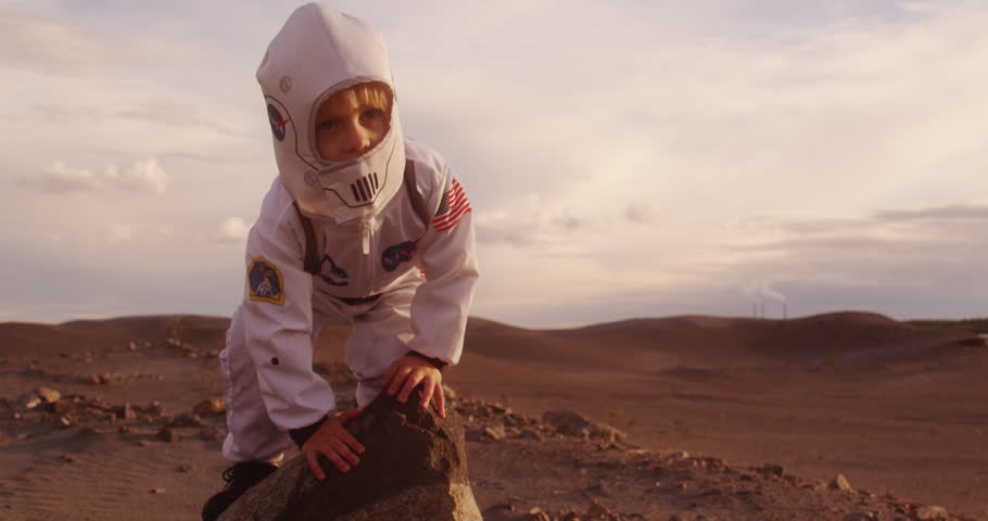 A small child in a NASA suit jumps off a cliff. Russia. Kostomuksha. 14.08.2018. | Shutterstock HD Video #1015426072
