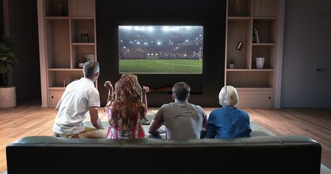 Group of students are watching a soccer moment on the TV and celebrating a goal, sitting on the couch in the living room. The living room is made in 3D.