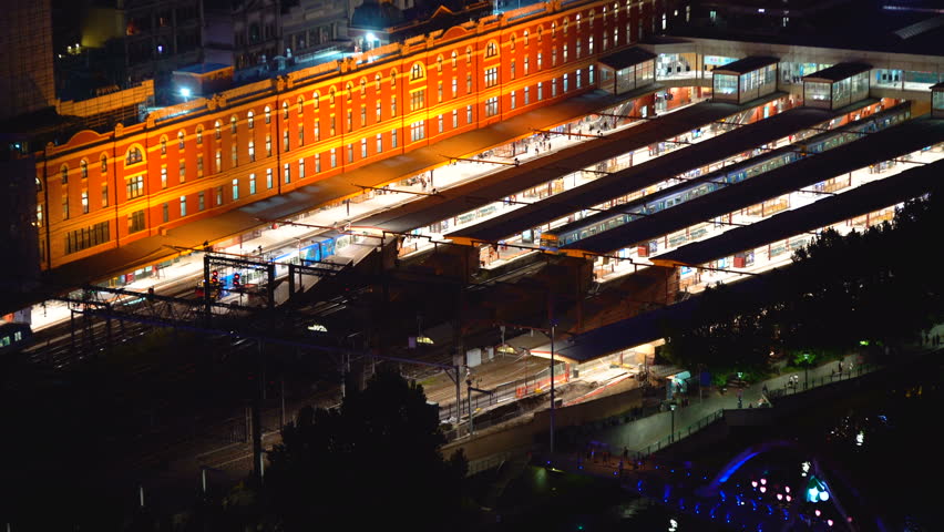 Melbourne City evening commute from Flinders Street Station at night illuminated lights of building platforms and trains Australia