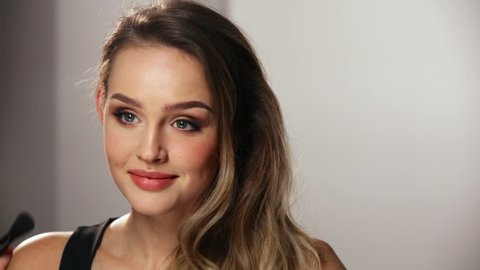 Woman With Beauty Face Applying Makeup Blush With Brush