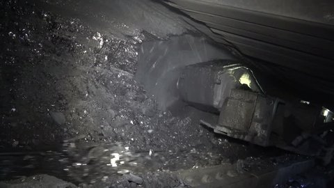 Coal miner produces coal. Coal mining in a real mine