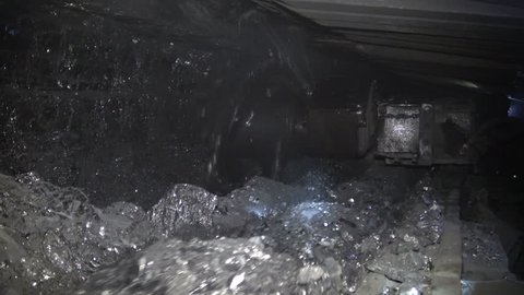Coal miner produces coal. Coal mining in a real mine