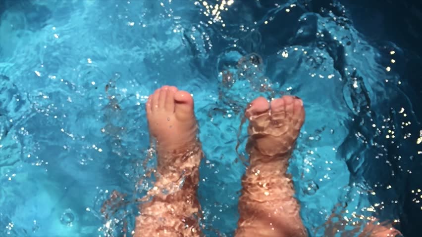 Baby feet beating the water of a swimming pool | Shutterstock HD Video #1015459648