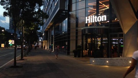 BELGRADE, SERBIA - AUGUST 14, 2018: Hilton logo on the entrance their newly opened hotel of Belgrade, during the evening. Hilton is one of the biggest brands of luxury hotels
