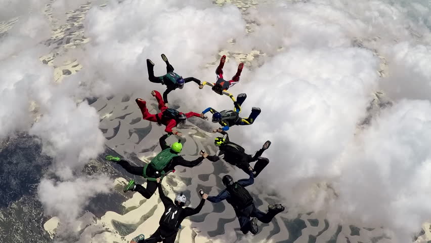 skydiving big group over the clouds, Brazilian dunes. Freedom concept