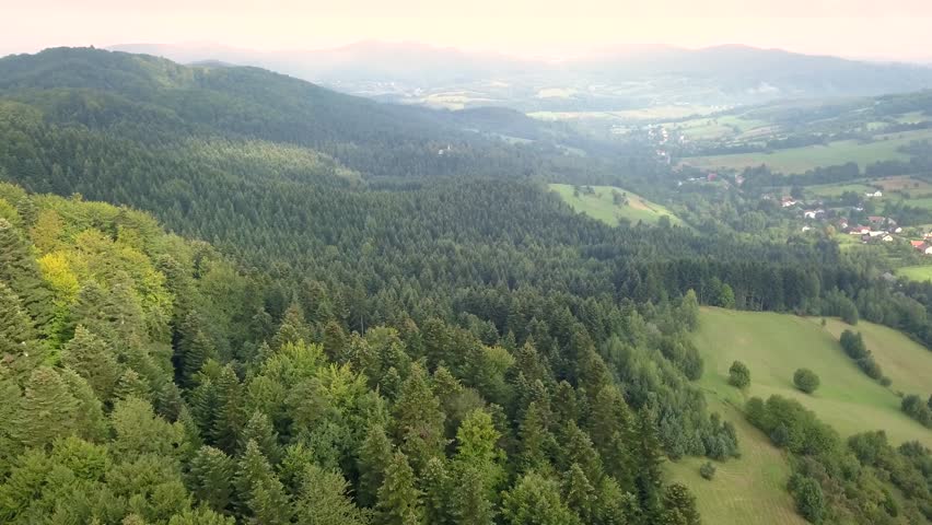 Beautiful aerial shot of green hills and valleys. Nature of Bieszczady Mountains seen from above.