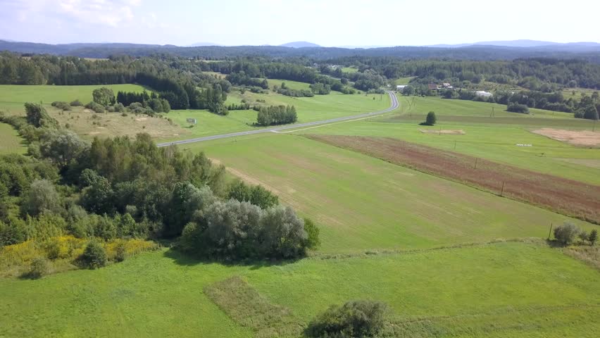 Beautiful aerial shot of green hills and valleys. Nature of Bieszczady Mountains seen from above.