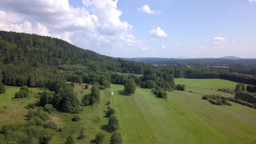 Beautiful aerial shot of green hills and valleys. Nature of Bieszczady Mountains seen from above.
