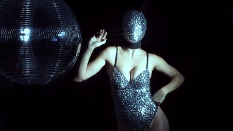 amazing woman dancing in diamond covered face mask and costume