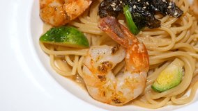 Motion video of seafood pasta / Spaghetti with shrimp on white dish (Selective Focus)