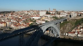 Tram crossing Dom Luis I Bridge in Porto, Portugal in the sunny moning
