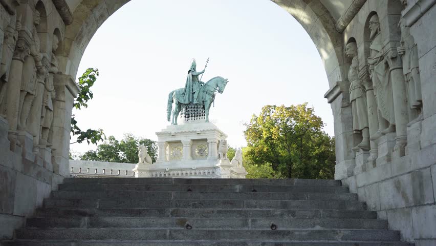 Beautiful woman walks down the stairs in the castle against the background of the monument in Budapest