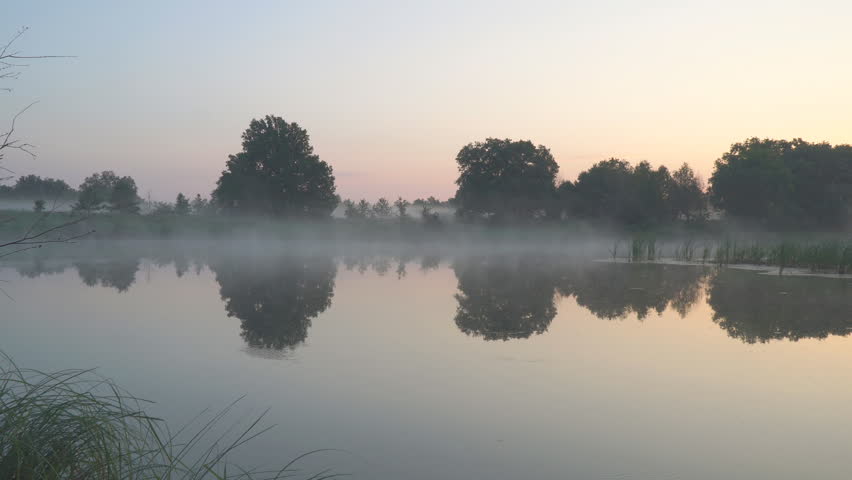 Morning fog on a quiet beautiful lake