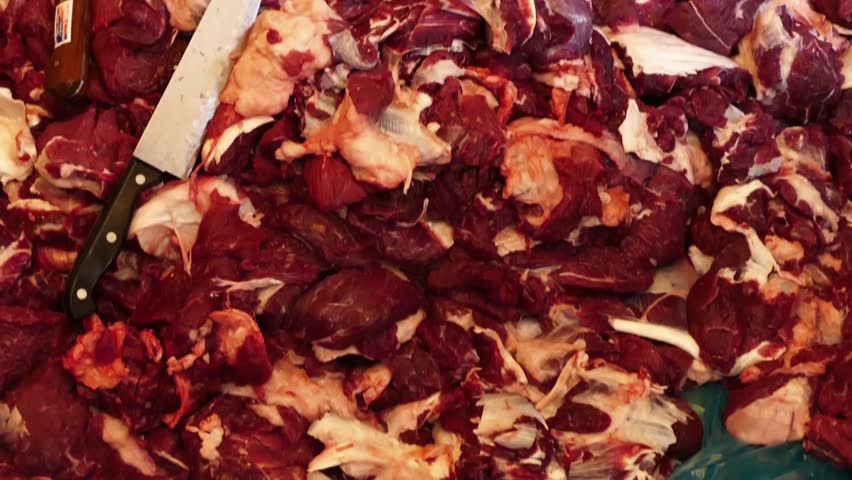 the butcher and the pile of meat on the floor, too much cow meat, piecewise veal,