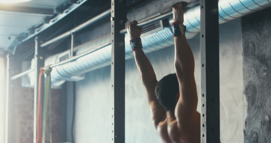 HANDHELD portrait of Caucasian male athlete doing high intensity workout in a functional gym. 4K UHD