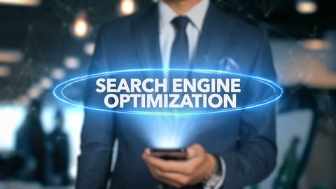 Businessman With Mobile Phone Opens Hologram HUD Interface and Touches Word - SEARCH ENGINE OPTIMIZATION
