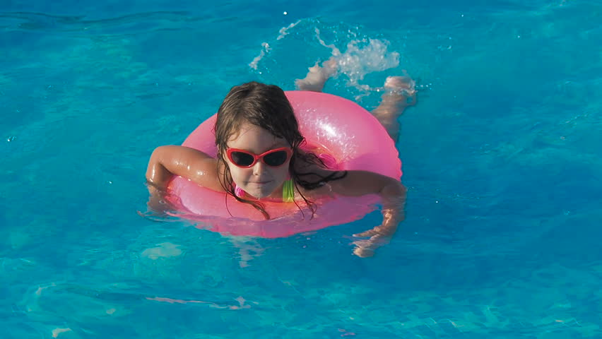 A happy child is swimming in the pool. | Shutterstock HD Video #1015509853