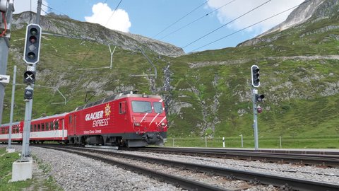 Red train Glacier Express trainstation Oberalppass 2064mtr. above sealevel. Andermatt, Switzerland