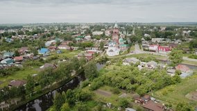 Picturesque scape of Russian town of Yuryev-Polsky on Koloksha River with Church of Intercession of Holy Virgin and Church of St. Nikita Martyr
