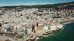 Landscape of picturesque Spanish town of Sitges with church  on Mediterranean seaside 