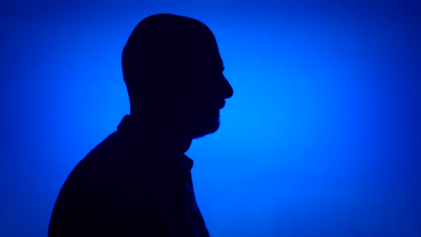 Silhouette of senior man gamer playing video game online. Male 