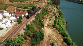 4k Aerial footage of steam vapor train leaving the village, Pinhão, Alto Douro, Portugal.