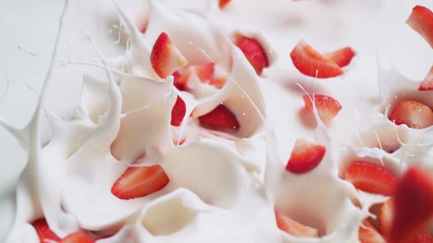 Tossing cut strawberries in yoghurt. Shot with high speed camera, phantom flex 4K. Slow Motion.
