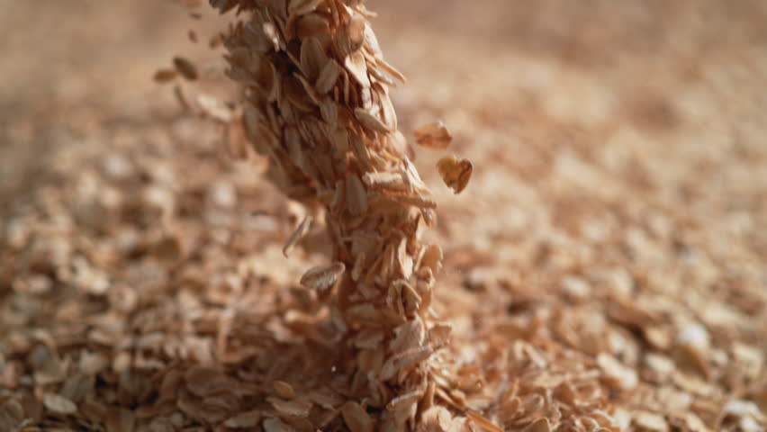 Camera follows throwing oats over a pile of oats. Shot with high speed camera, 4K. Slow Motion. Royalty-Free Stock Footage #1015533112