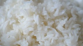 Motion video of close up steaming white rice.