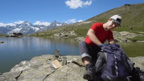 Young Hiker Pouring Water in Aluminum Cup To Make Coffee or Tea 