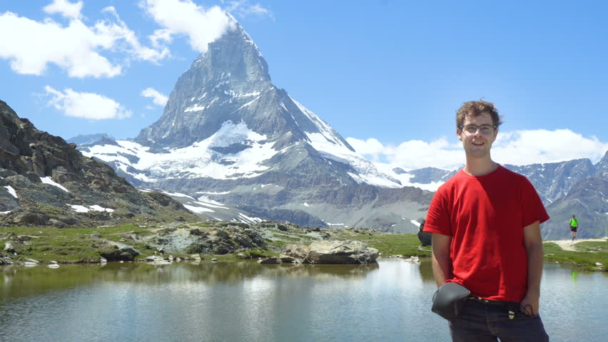 Happy Young Man Smiling In front of Iconic Matterhorn Mountain 