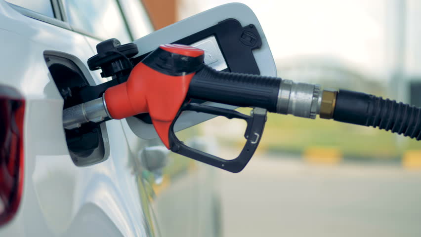 Petrol station equipment fuelling a car, close up. | Shutterstock HD Video #1015549093