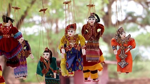 BAGAN, MYANMAR, MAY 17 2018,  Traditional Myanmar puppets hangs on rope on tree in area Buddhist temple.