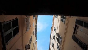 Beautiful panoramas are taken to the drone of narrow streets in a small European Italian French town by the sea. colored houses. Video in motion. Blue sky. French Riviera. Ancient houses and streets 