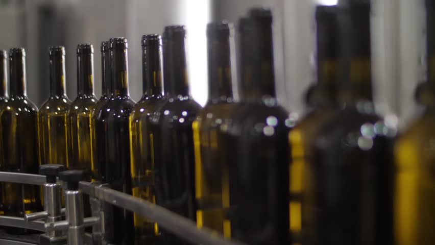 Wine bottles in conveyor belt  bottling line industry slow motion | Shutterstock HD Video #1015561786
