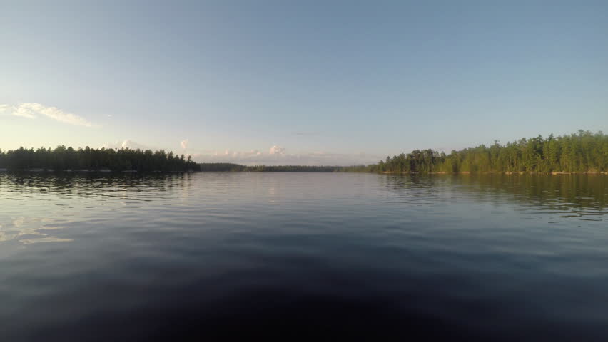 Boating Across The Smooth Water of Rainy Lake in Minnesota