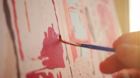 close up artist hand hold brush painting picture on canvas in art studio sunset artists studio creativity drawing design girl pattern ornament sun art colourful paper fine art color slow motion