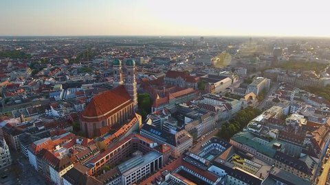 Aerial view of Munich Germany City Skyline at sunset from sky, Flying By Over Munich City Center at sunset view of Marienplatz and Frauenkirche Cathedral Church in Munich old town. Munich Cityscape.
